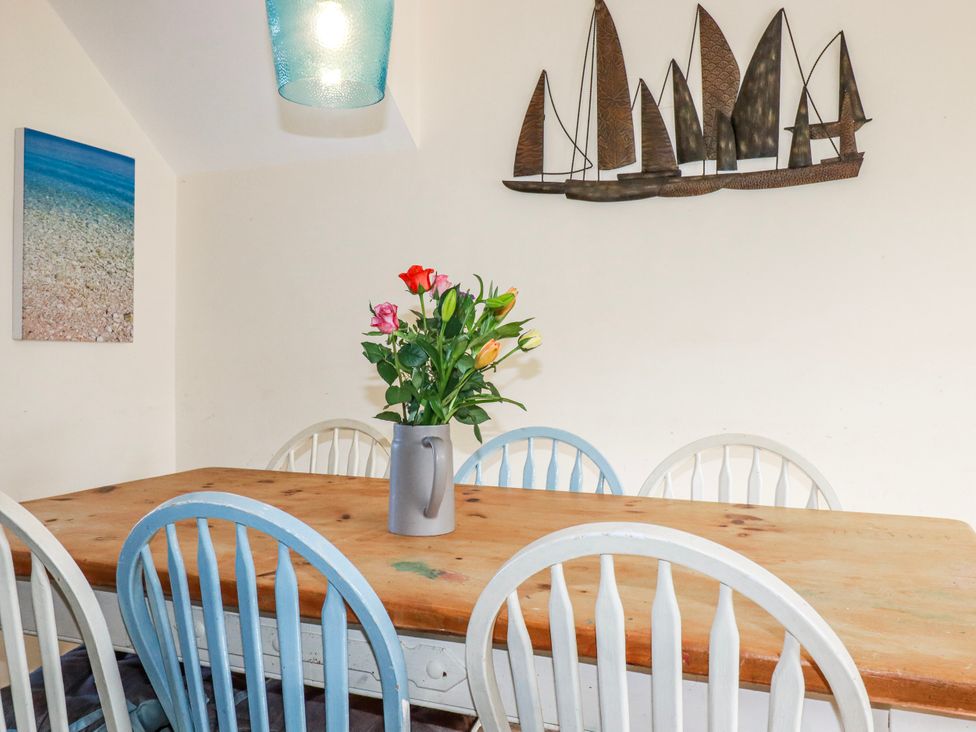 A dining room with a table and chairs at 3A Grannys Lane, Perranporth