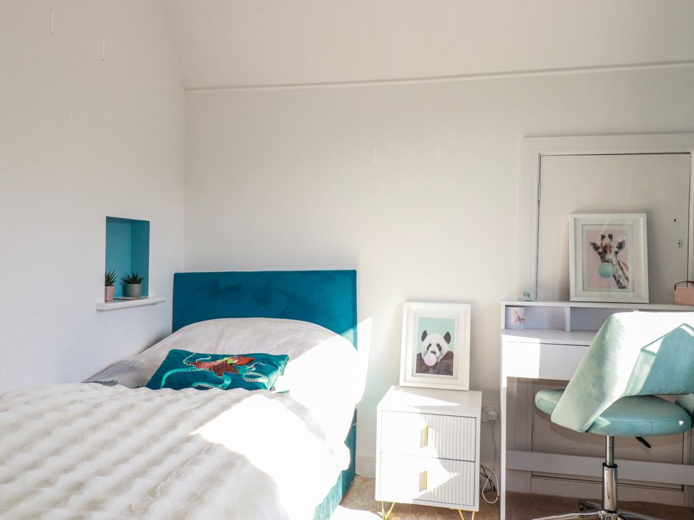 A bedroom with a bed and desk at 3A Grannys Lane Perranporth