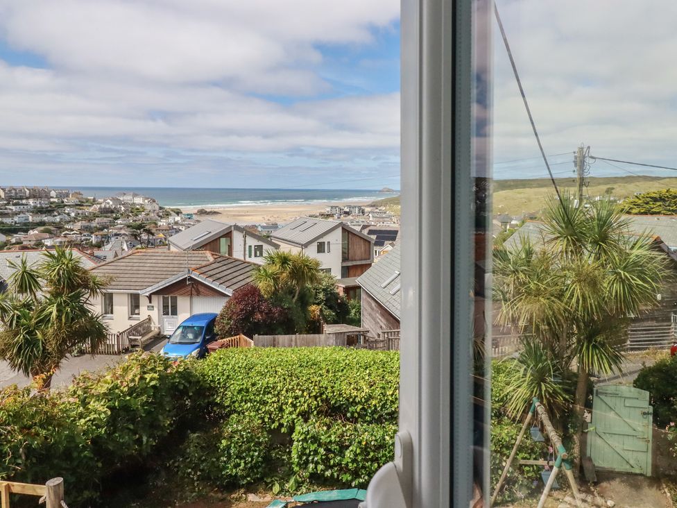 A view of houses and the sea from a window at 3A Grannys Lane in Perranporth