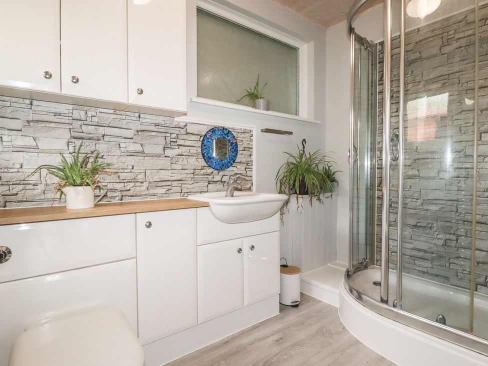 A bathroom with a sink and shower at 3A Grannys Lane in Perranporth