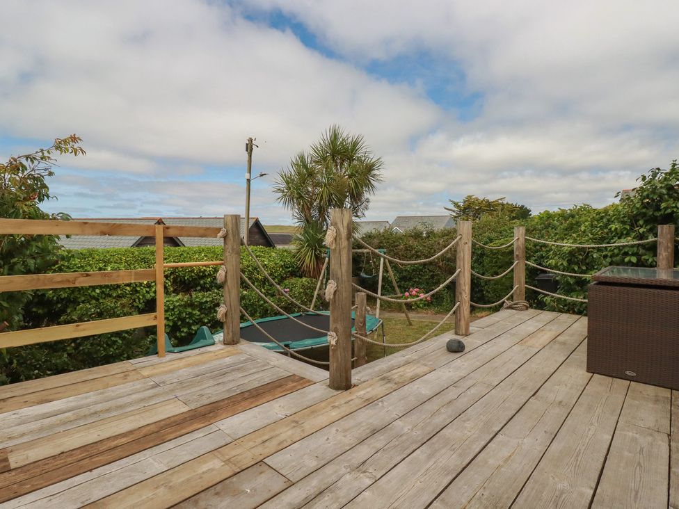 An outdoor area with decking and a garden at 3A Grannys Lane Perranporth
