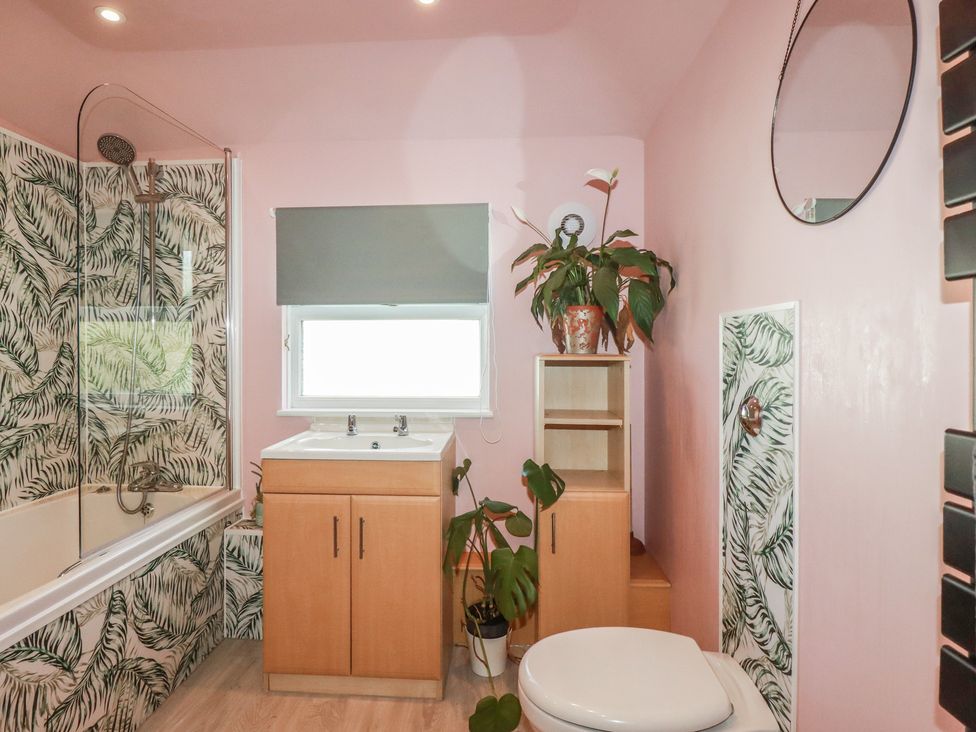 A bathroom with a shower, bathtub, sink, and toilet at 3A Grannys Lane in Perranporth