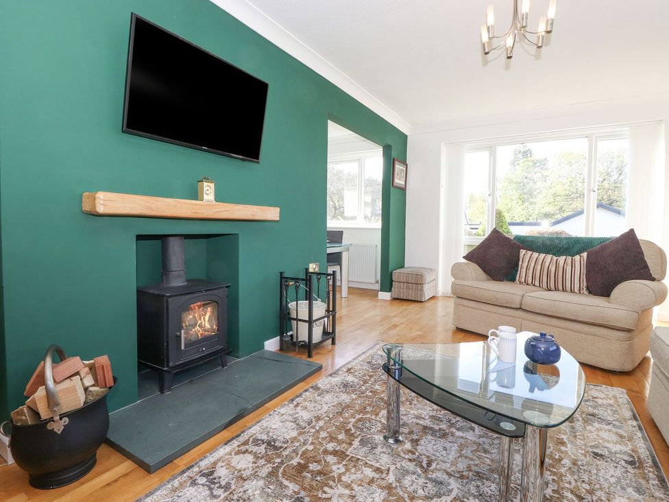 A living room with a fireplace and television at Wansfell View in Ambleside