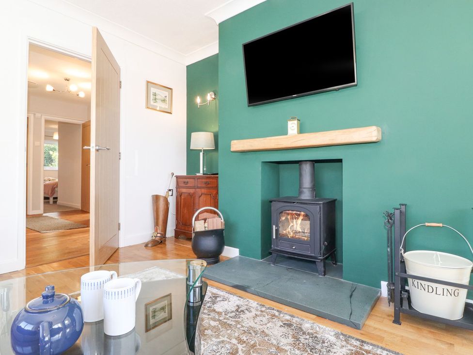 A living room with a fireplace and television at Wansfell View in Ambleside