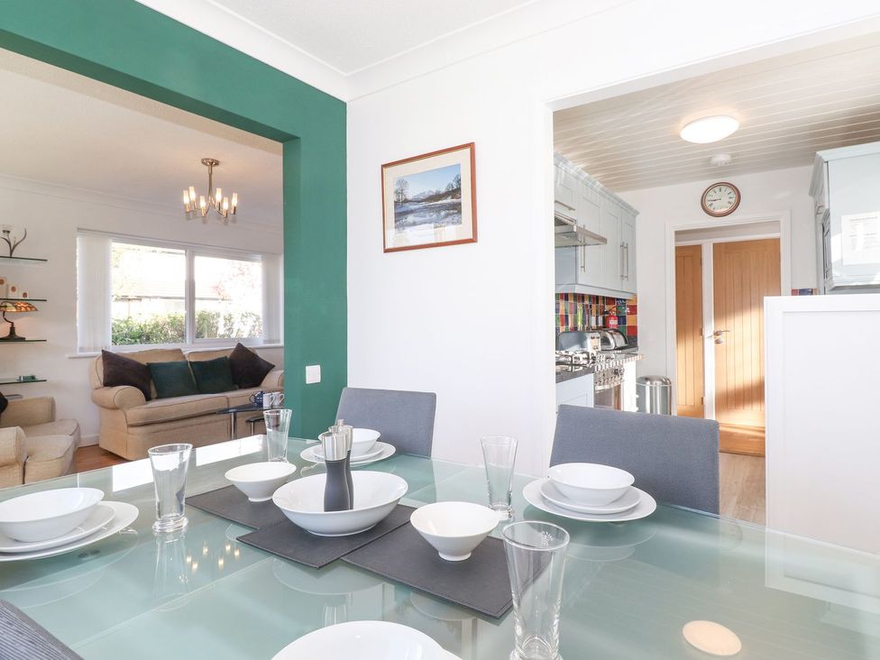A dining room with a table set for a meal at Wansfell View in Ambleside