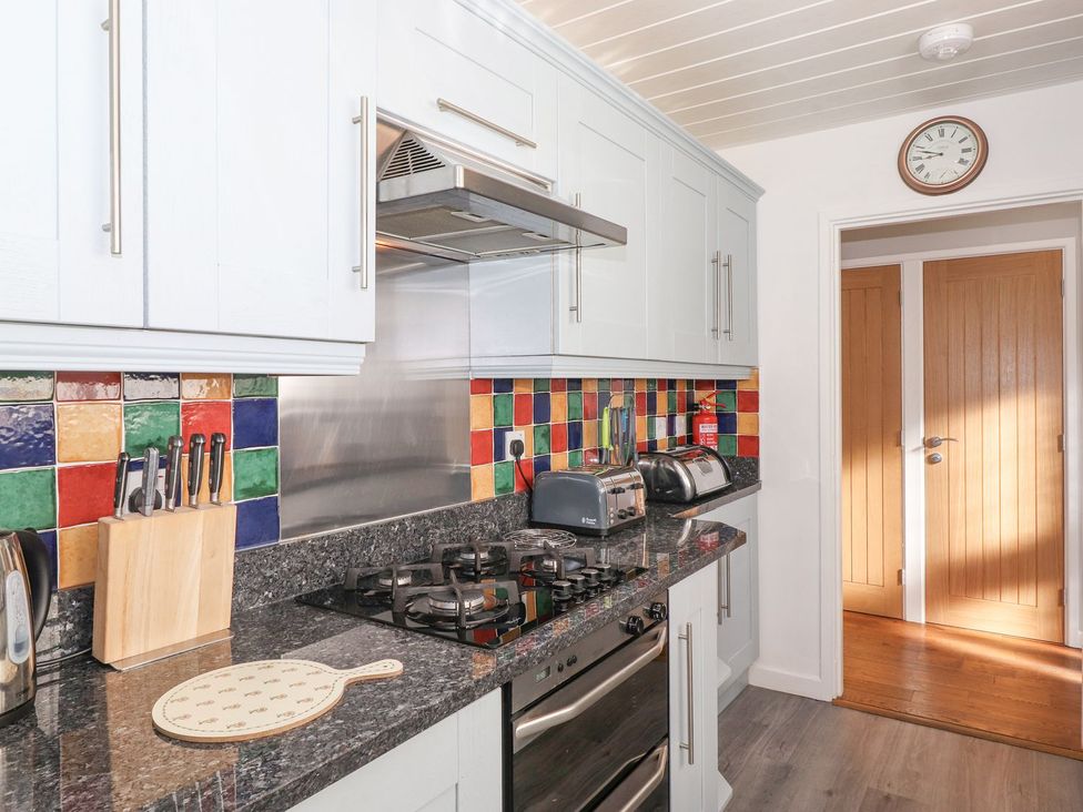 A kitchen with cabinets and appliances at Wansfell View in Ambleside