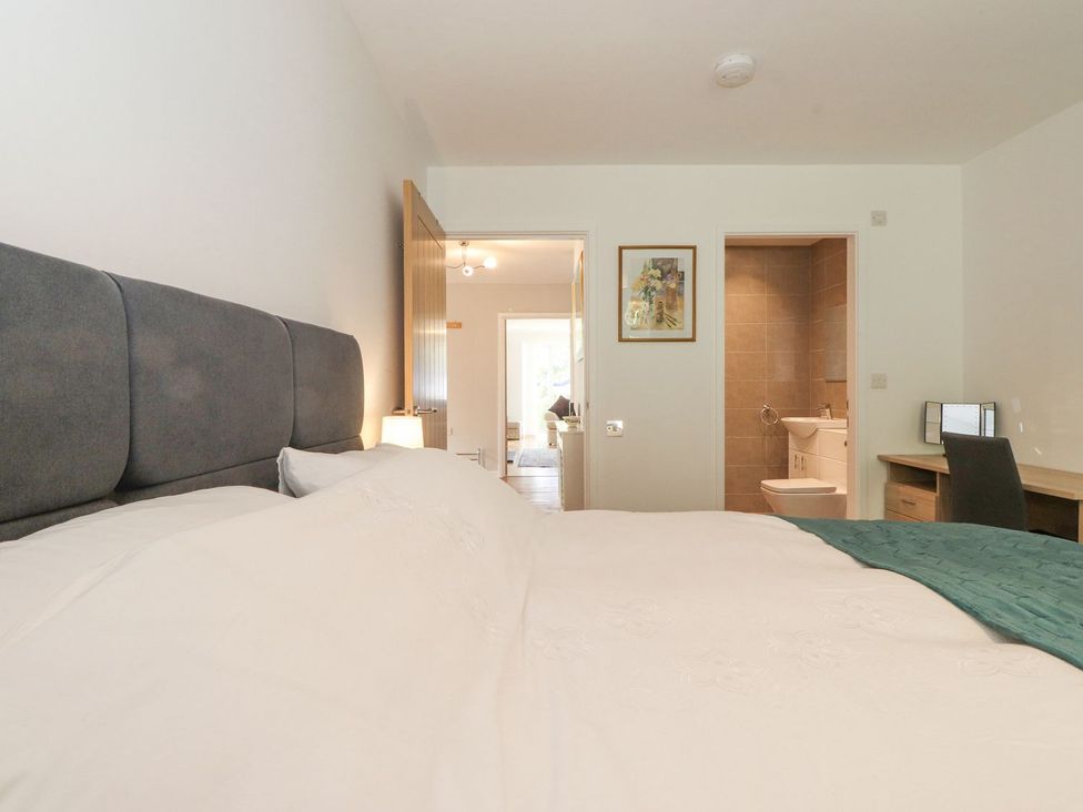 A bedroom with a bed and a desk at Wansfell View in Ambleside