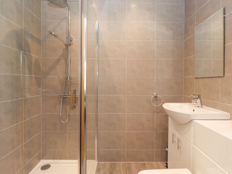 A bathroom with a shower and sink at Wansfell View in Ambleside
