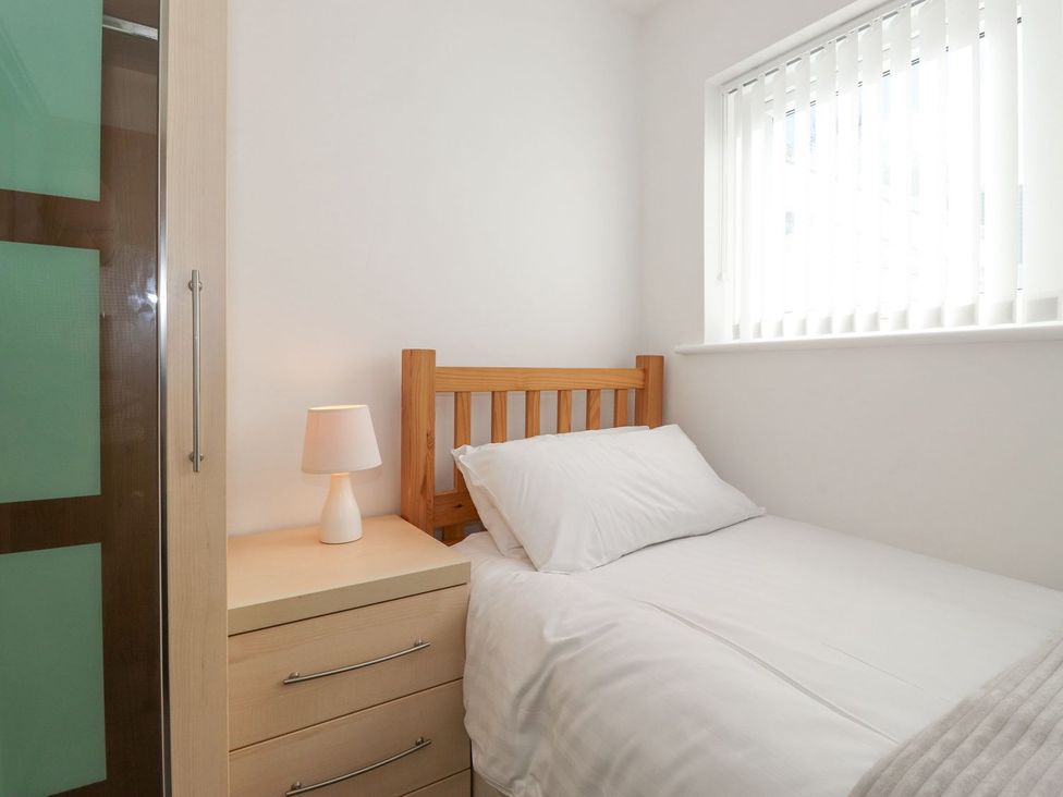 A bedroom with a single bed and a nightstand at Wansfell View in Ambleside