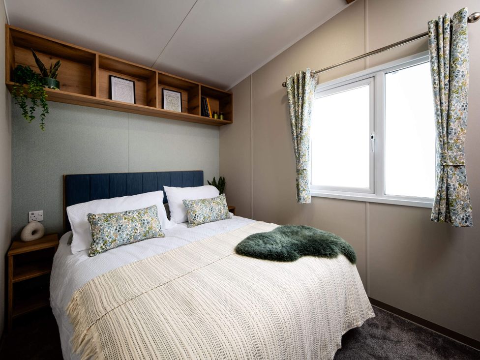 A bedroom with a double bed and shelves at Ashberry 39 x 12 Three Bed- 3 Northwich