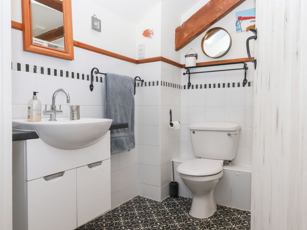 A bathroom with sink and toilet at Pillars in Barnstaple