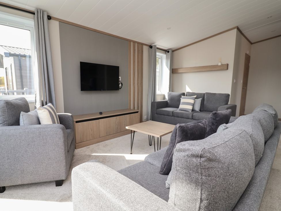 A living room with sofas and a television at No.11 - Cedar Lodge in Delamere