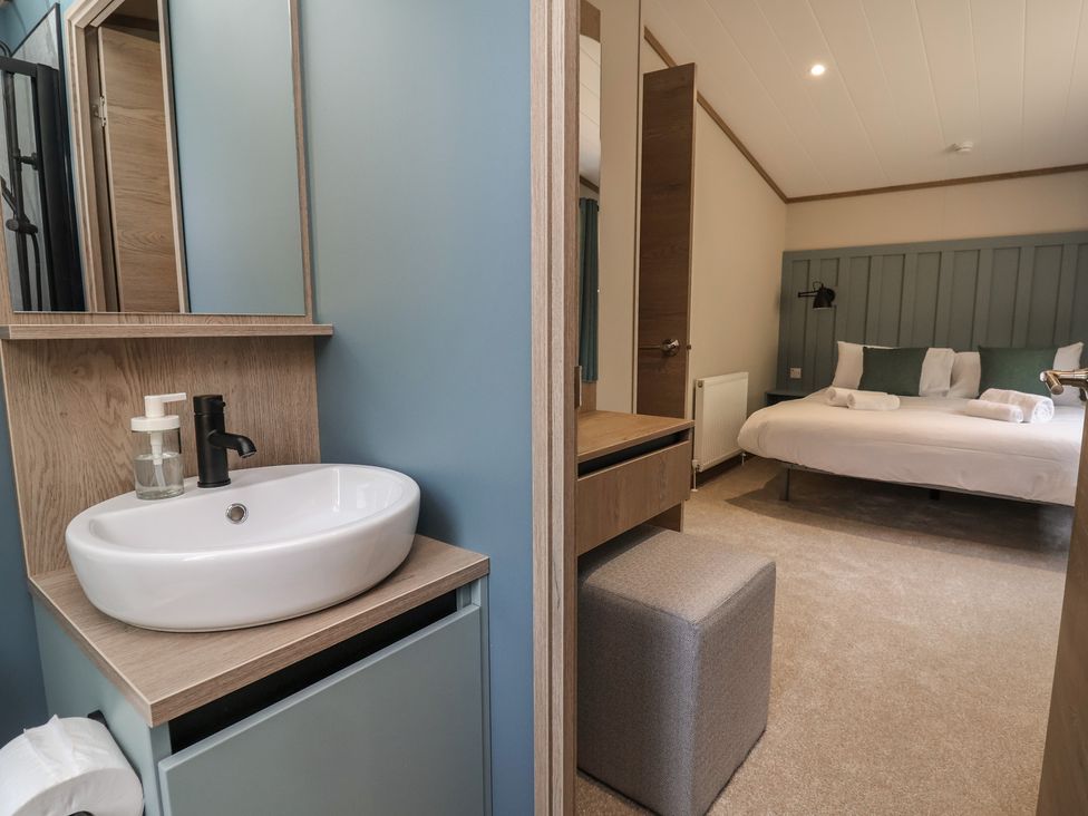 A bathroom with a sink and mirror at No.11 - Cedar Lodge in Delamere