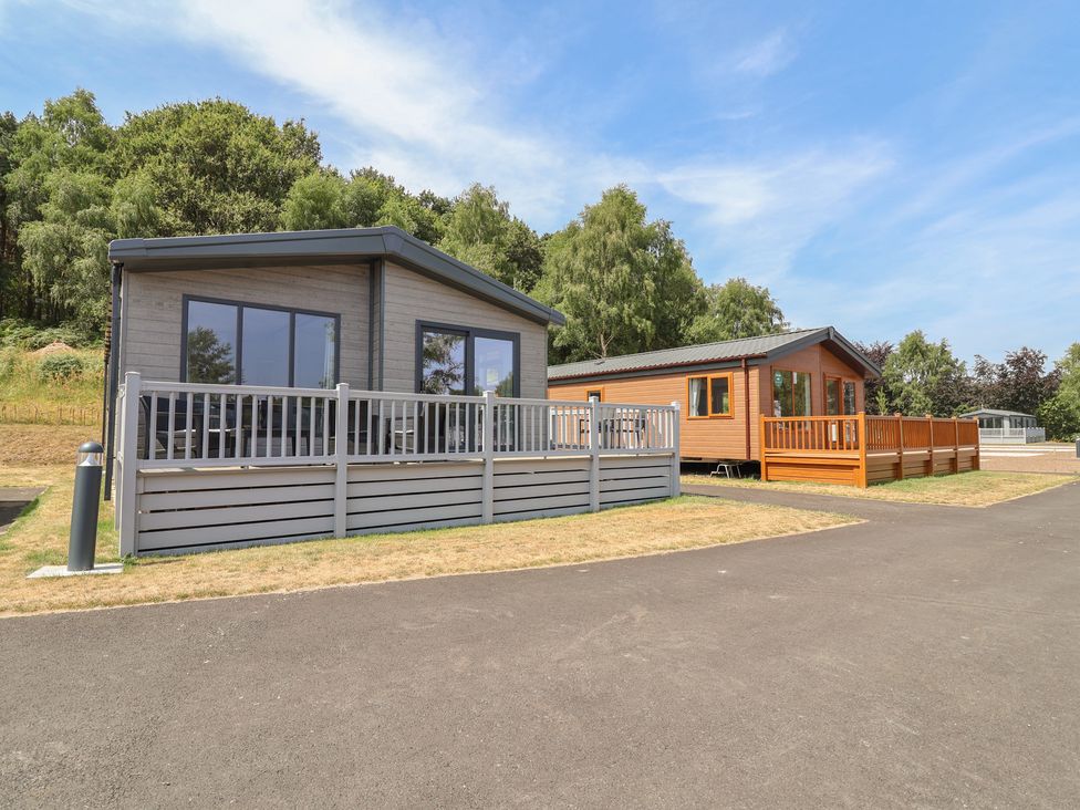 Two cabins with decks in a natural setting at Cedar Lodge 3 Bedrooms with hot tub Delamere