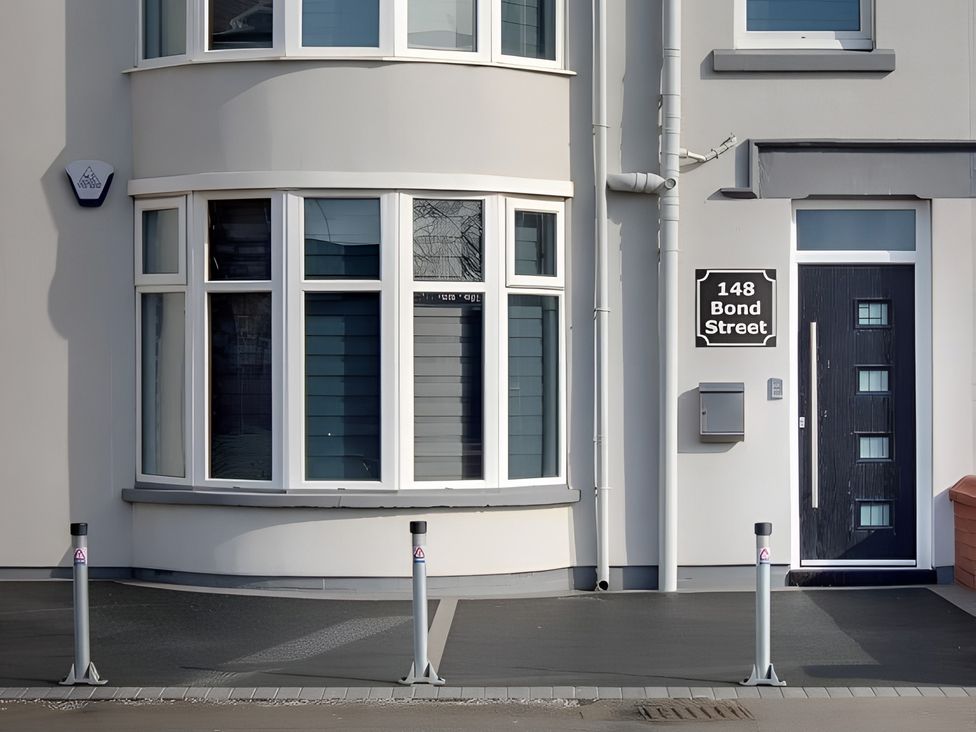 An entrance with a door and windows at 148 Bond Street in Blackpool