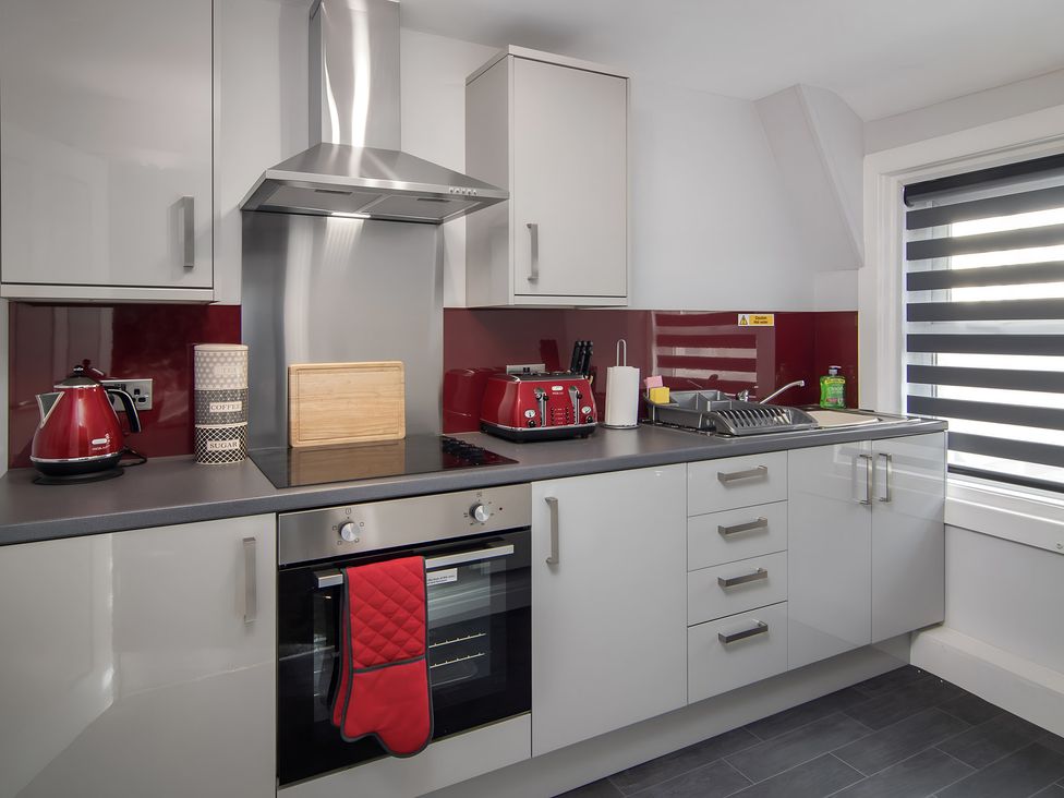 A kitchen with appliances and a sink at Apartment 3 in Blackpool