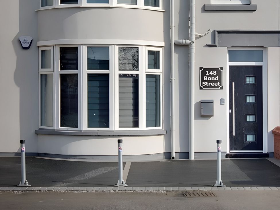 An outdoor entrance featuring a door and windows at 148 Bond Street in Blackpool