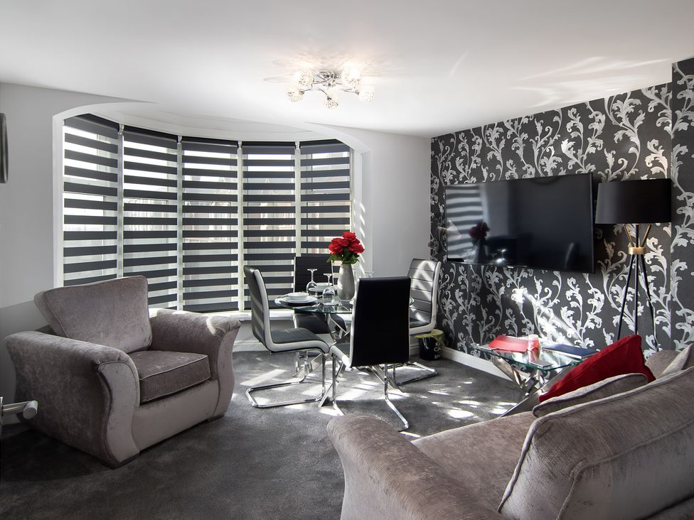 A living room with a sofa and television at Apartment 2 in Blackpool