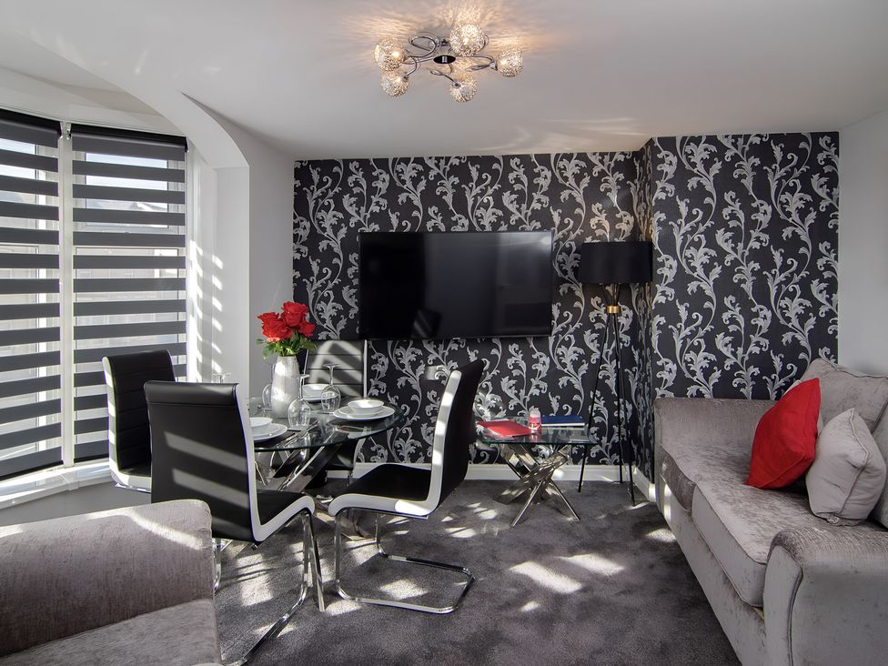 A living room with a dining table and sofa at Apartment 2 in Blackpool