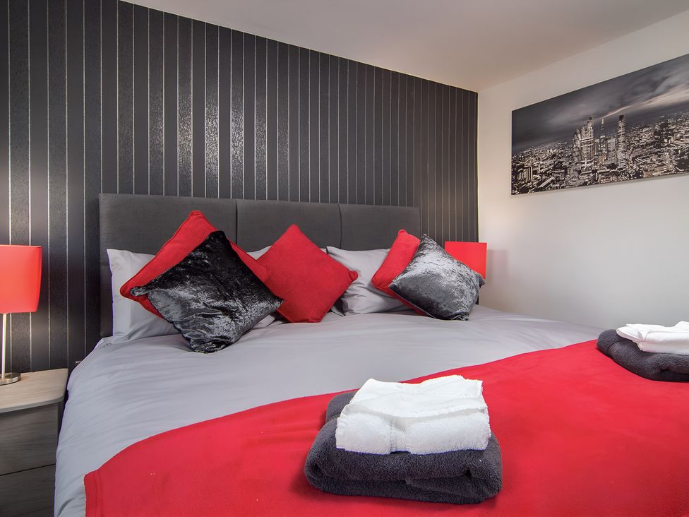 A bedroom with a bed and pillows at Apartment 2 in Blackpool