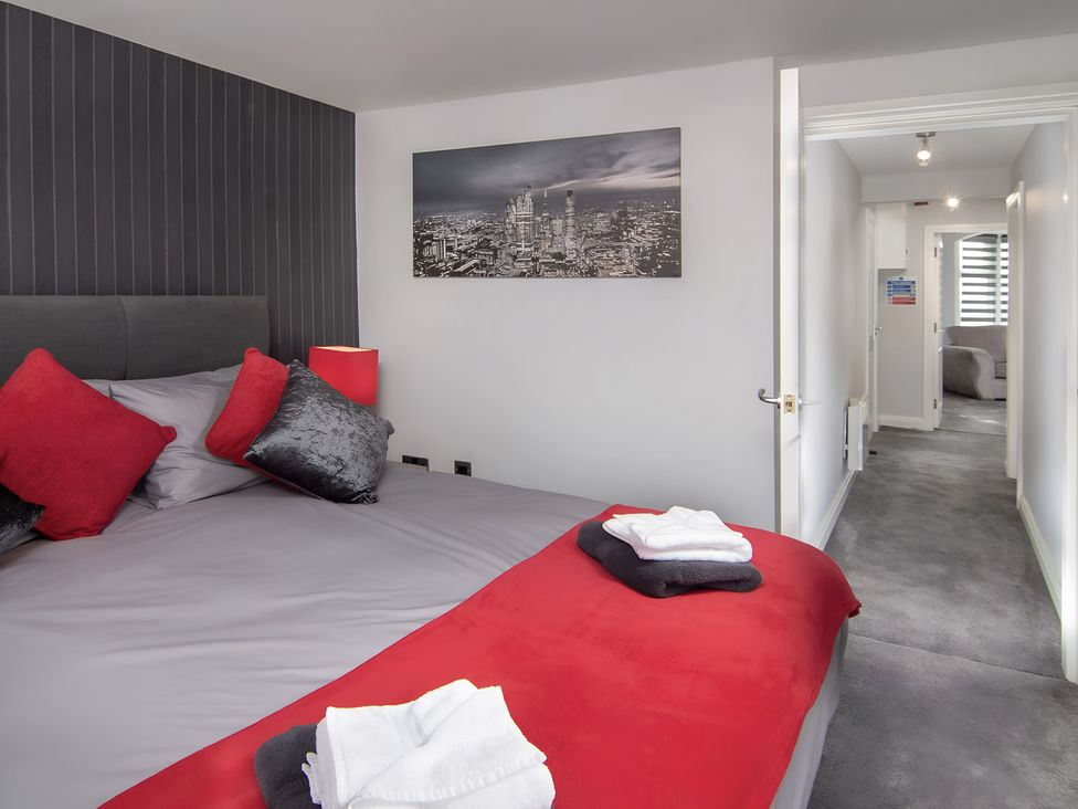 A bedroom with a bed and door at Apartment 2 Blackpool