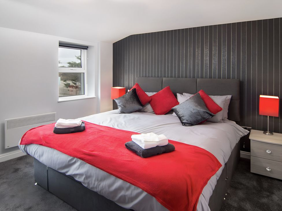 A bedroom with a bed and bedside lamps at Apartment 2 in Blackpool