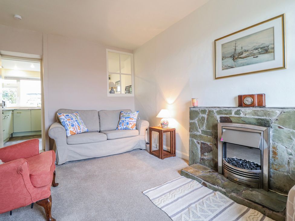A living room with a sofa and armchair at 12 Glyn Terrace Borth-Y-Gest