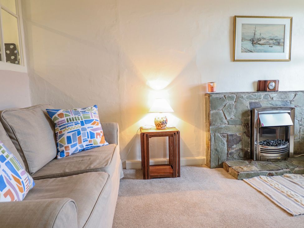 A living room with a sofa and lamp at 12 Glyn Terrace Borth-Y-Gest