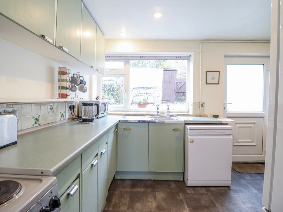 A kitchen with a sink and dishwasher at 12 Glyn Terrace in Borth-Y-Gest