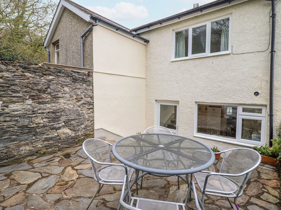 An outdoor patio with a table and chairs at 12 Glyn Terrace Borth-Y-Gest