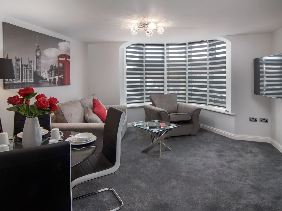 A living room with a sofa and chair at Apartment 1 in Blackpool