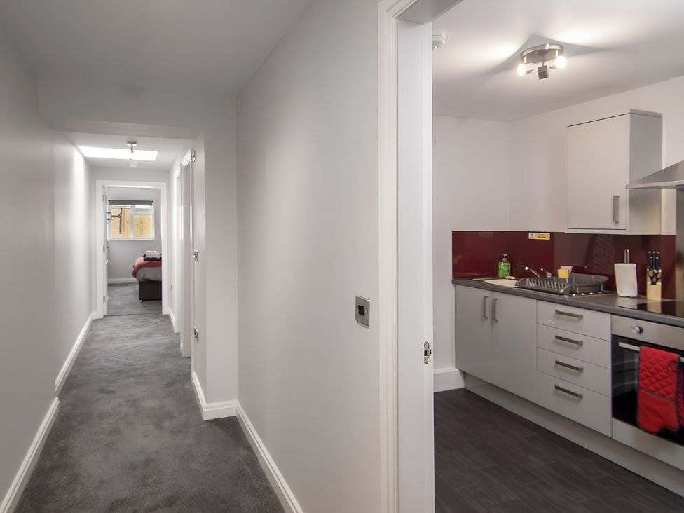 A kitchen with cabinets and a sink at Apartment 1 in Blackpool