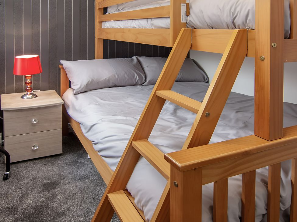 A bedroom with a bunk bed and a bedside table at Apartment 1 in Blackpool