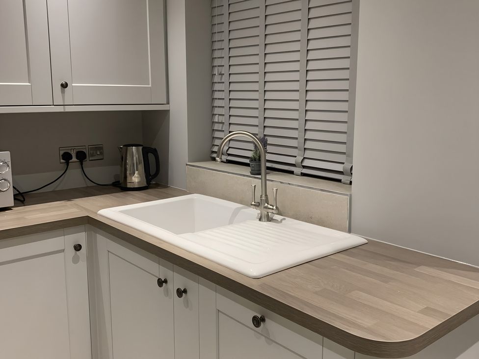 A kitchen with a sink and kettle at 43 Goose Green Road King's Lynn