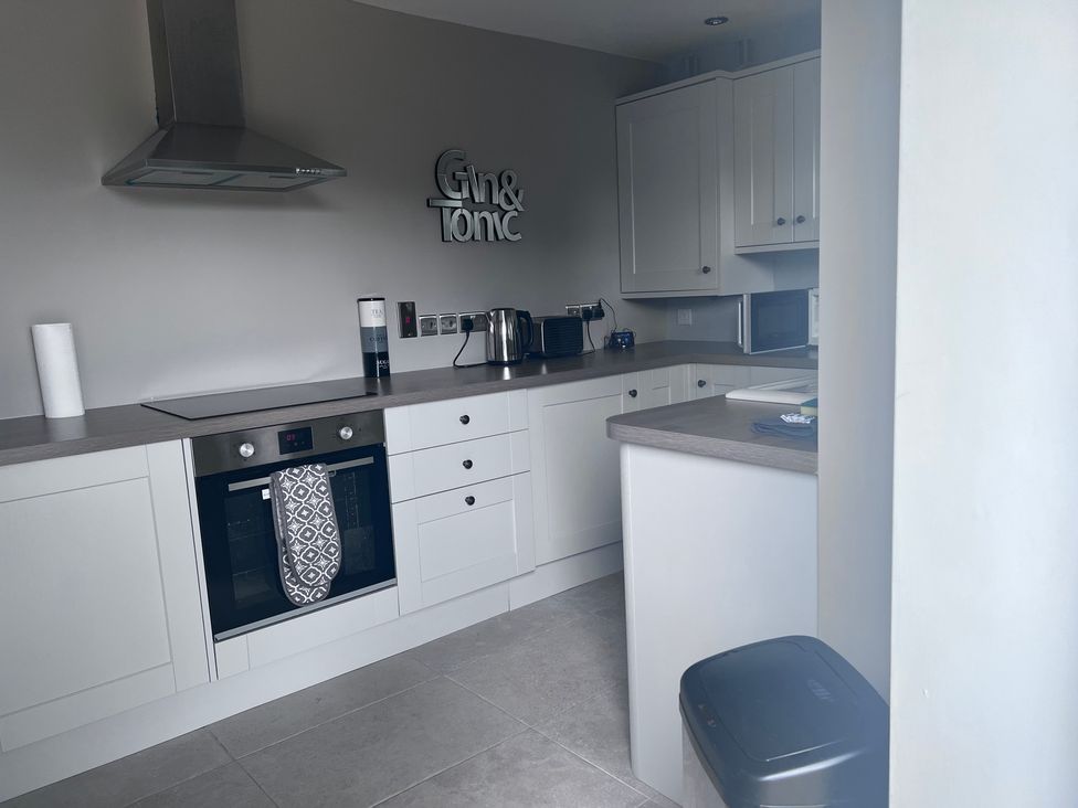 A kitchen with an oven and cabinets at 43 Goose Green Road in King's Lynn