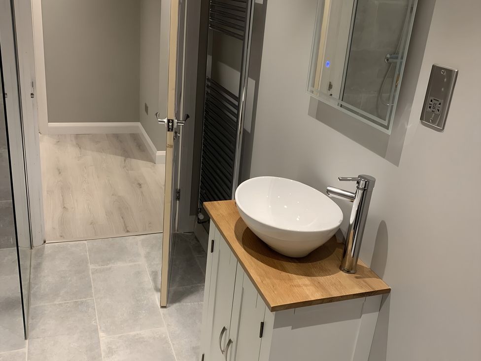 A bathroom with a sink on a wooden countertop at 43 Goose Green Road in King's Lynn