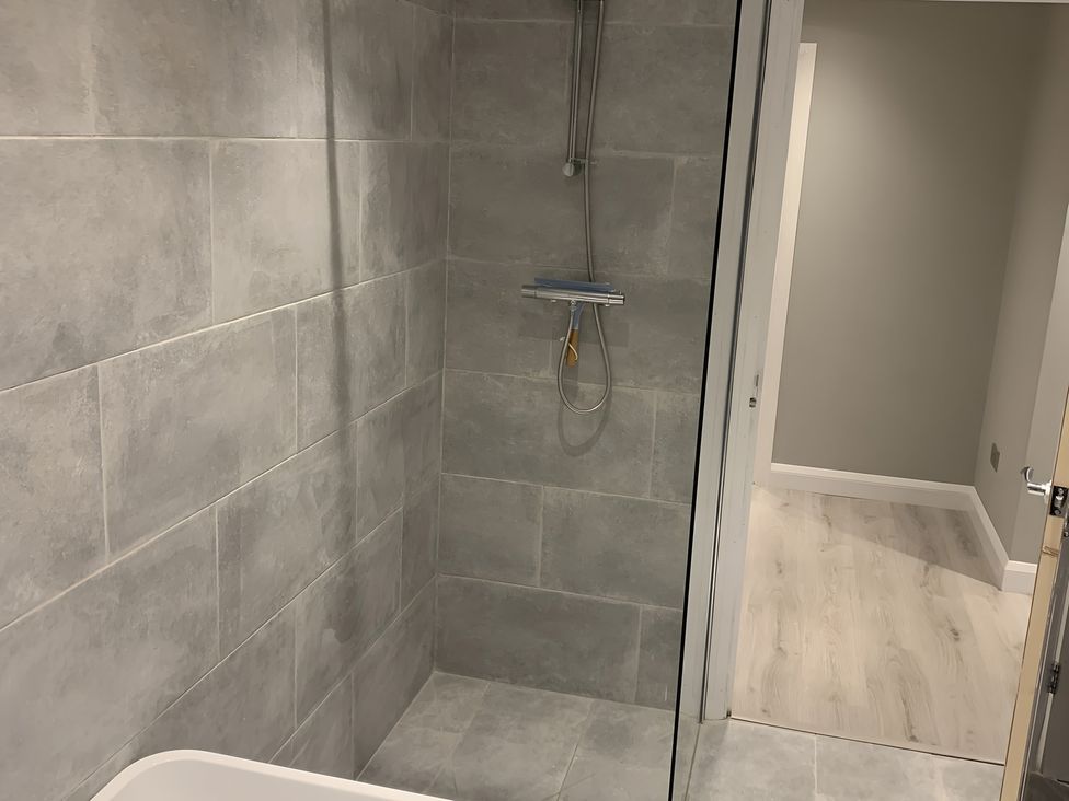 A bathroom with a shower and bathtub at 43 Goose Green Road King's Lynn