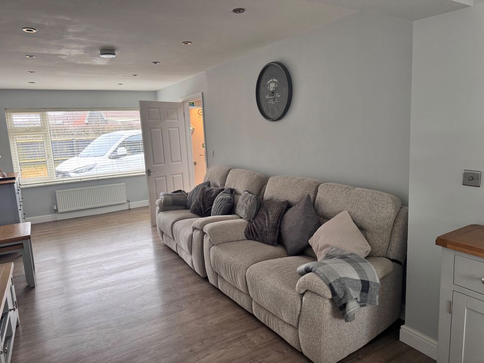 A living room with a sofa and window at 15 Lamsey Lane in King's Lynn