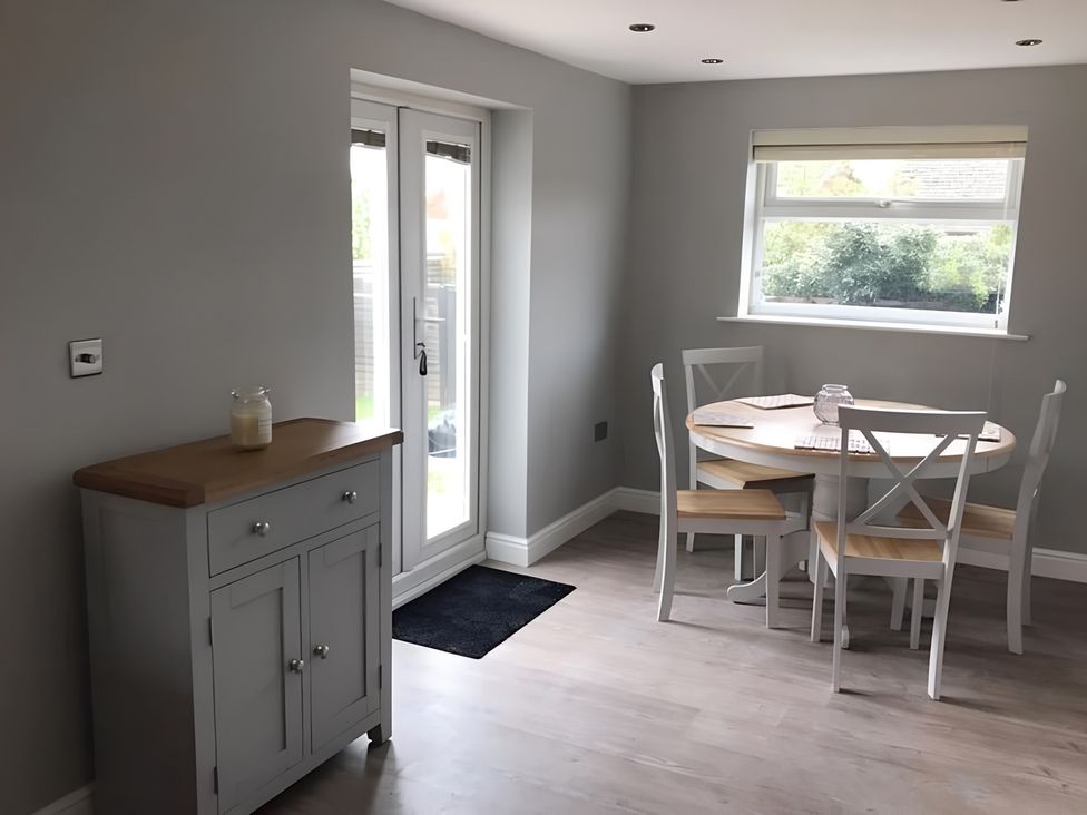 A dining room with a table and chairs at 15 Lamsey Lane in King's Lynn