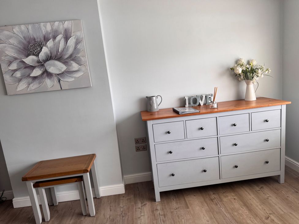 A dresser with a vase and jug in a dining room at 15 Lamsey Lane King's Lynn
