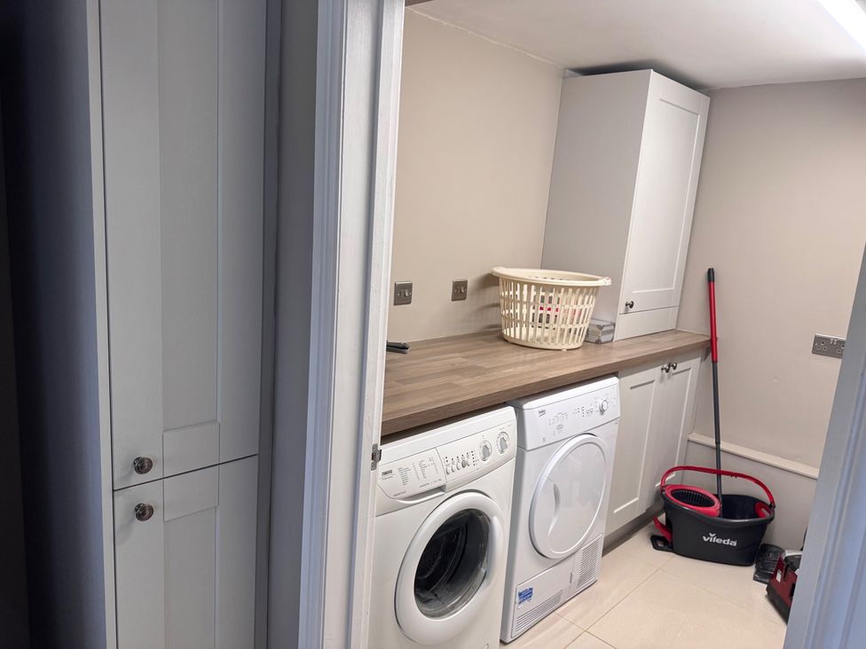 A laundry room with a washer and dryer at 15 Lamsey Lane in King's Lynn