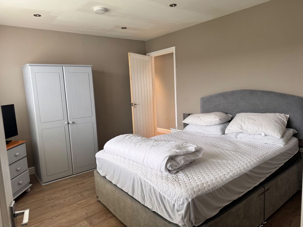 A bedroom with a bed and wardrobe at 15 Lamsey Lane King's Lynn