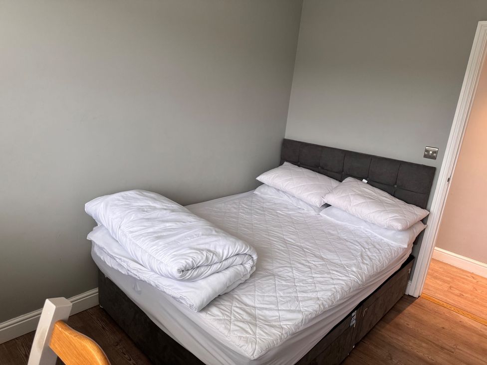 A bedroom with a bed and pillows at 15 Lamsey Lane in King's Lynn