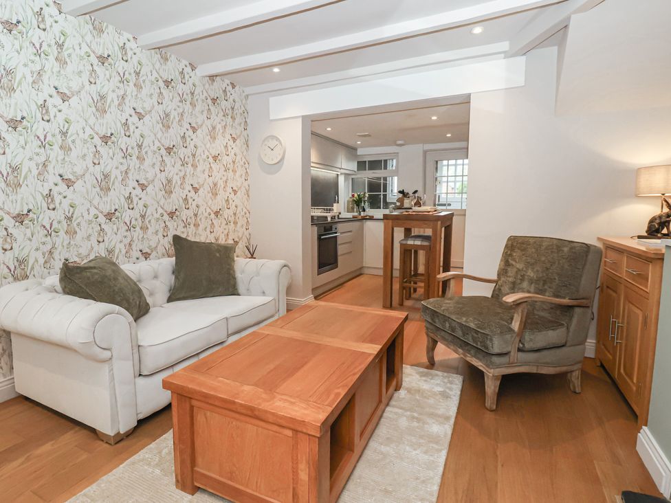 A living room with a sofa and a table at No.4 Main Street, Hull