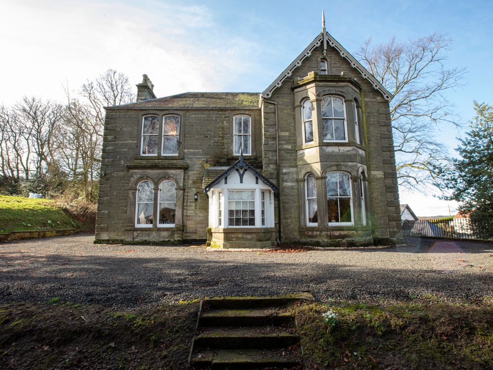 An exterior view of a house with windows and a front door at Newton Manor House in Cupar