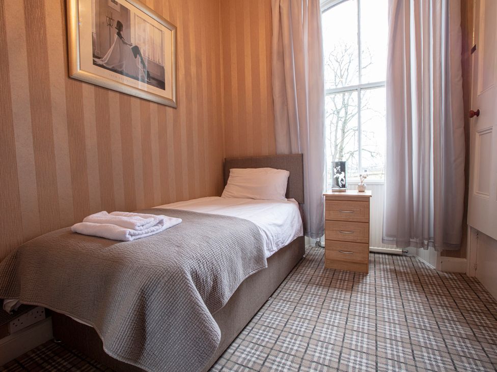 A bedroom with a bed and nightstand at Newton Manor House in Cupar