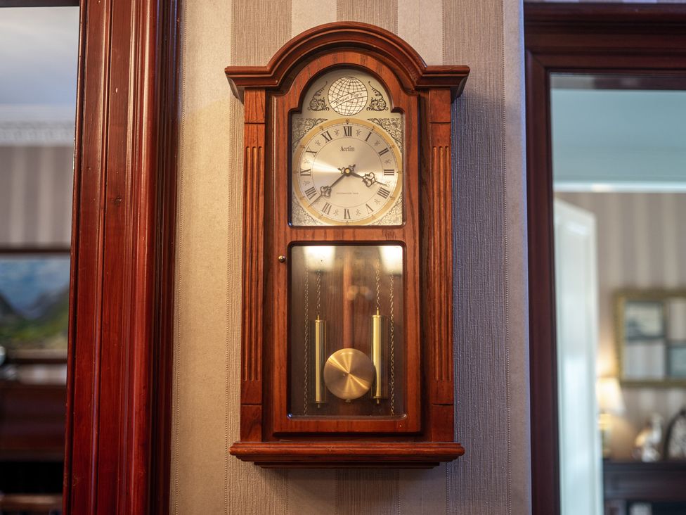 A wall clock with pendulum at Newton Manor House in Cupar