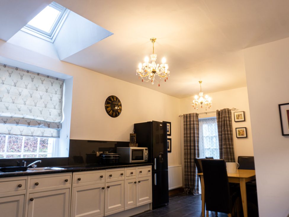 A kitchen with appliances and dining area at Newton Manor House in Cupar
