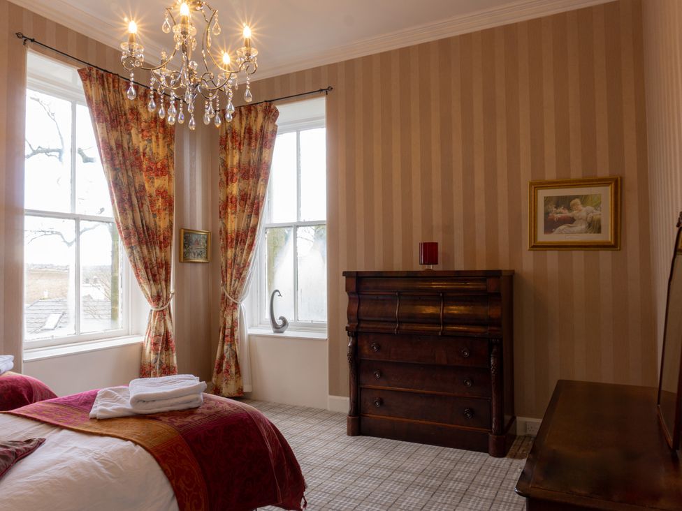 A bedroom with a bed and dresser at Newton Manor House in Cupar