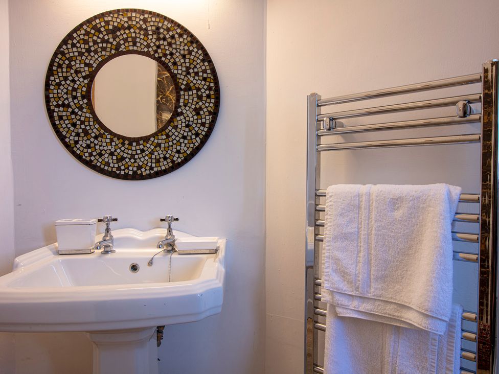 A bathroom with a sink and a mirror at Newton Manor House in Cupar